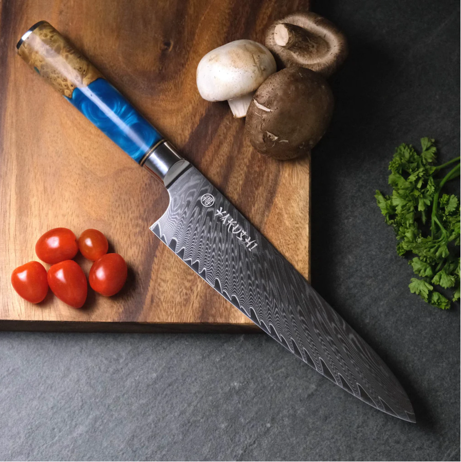 A knife on a cutting board with tomatoes and mushrooms.