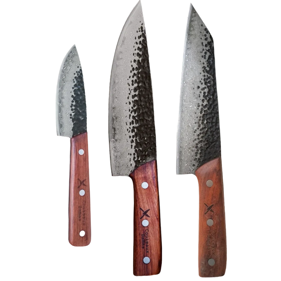 A set of damascus kitchen knives with a wooden handle on a red background.